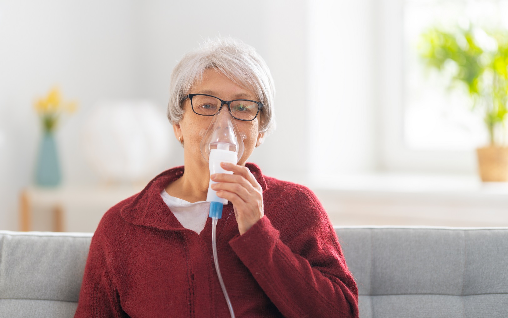 elderly woman using inhaler