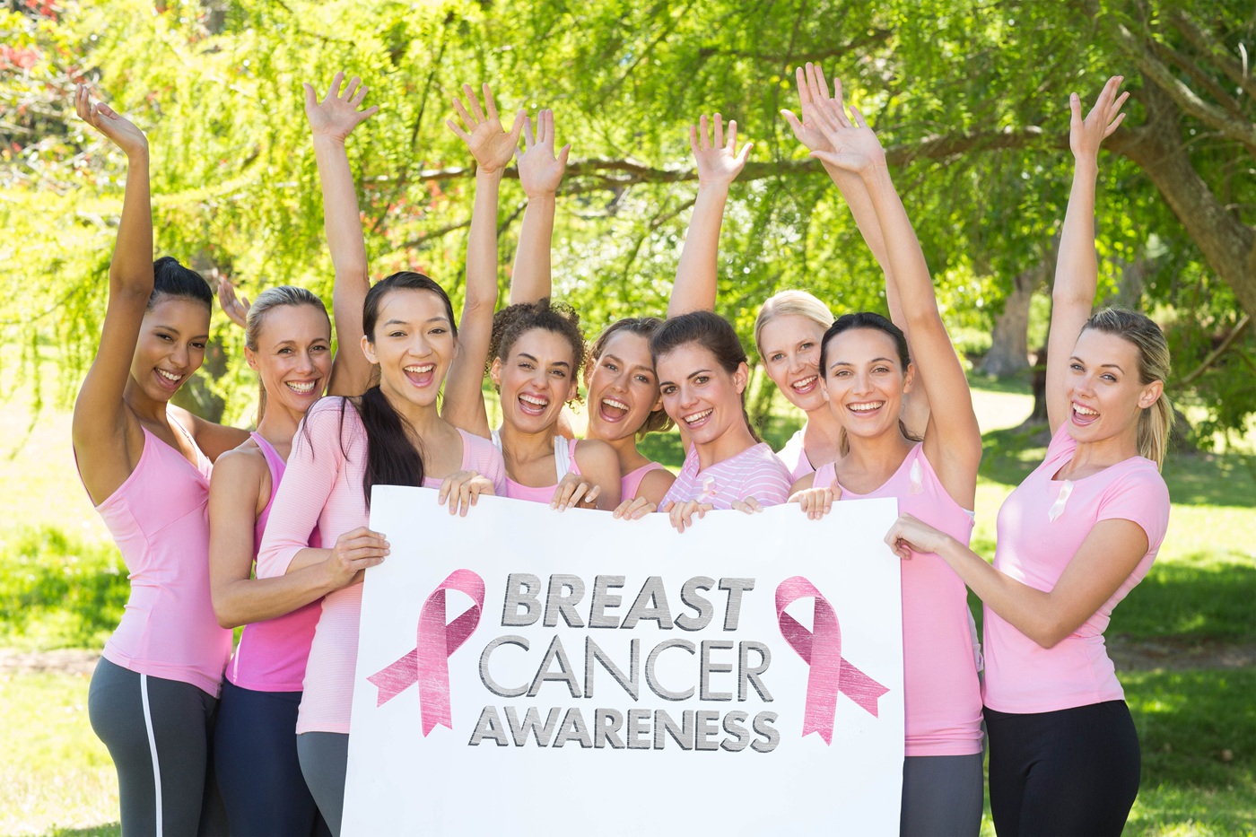 women support breast cancer awareness in a park 2026