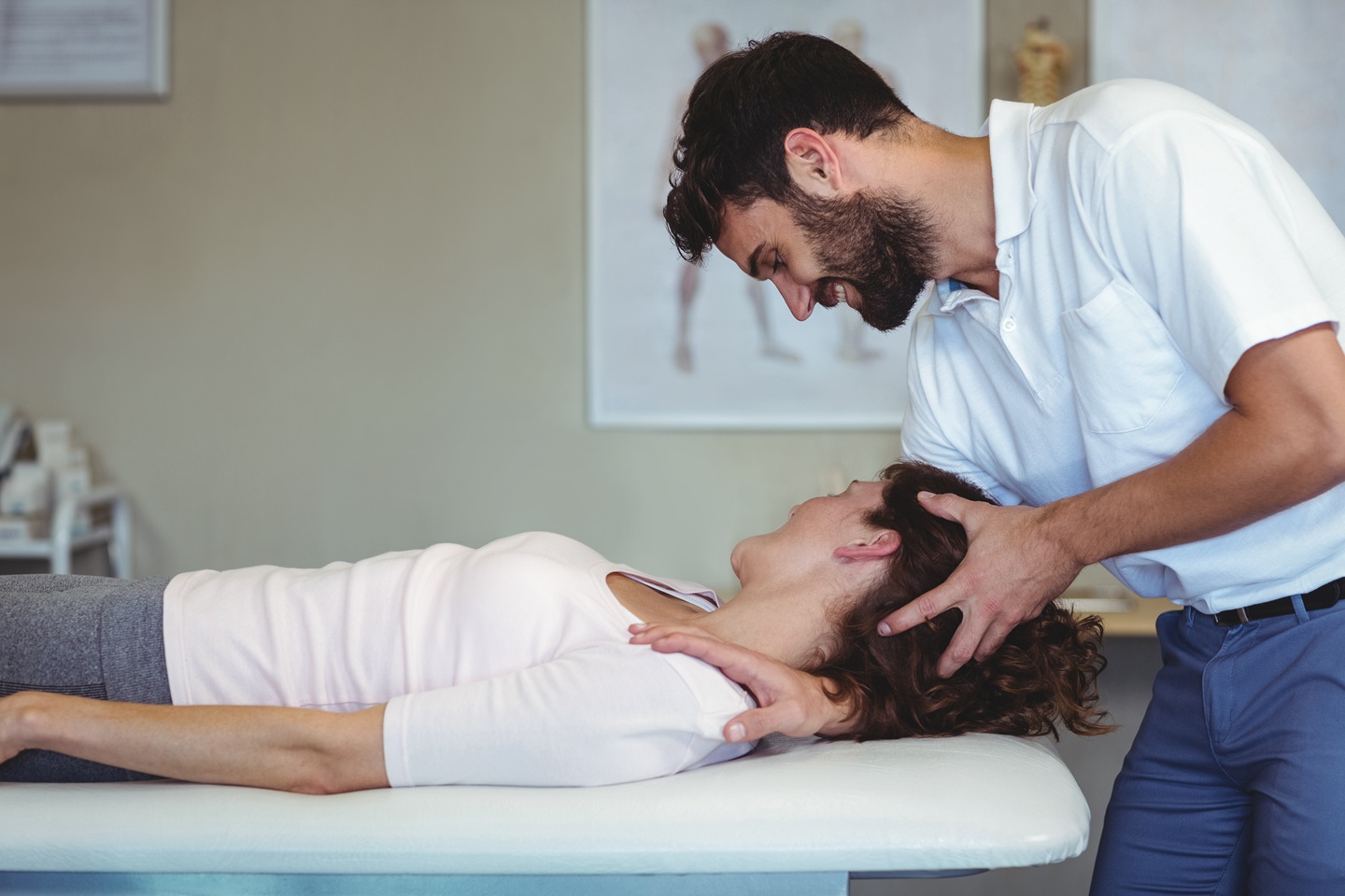 physiotherapist giving neck massage to a woman