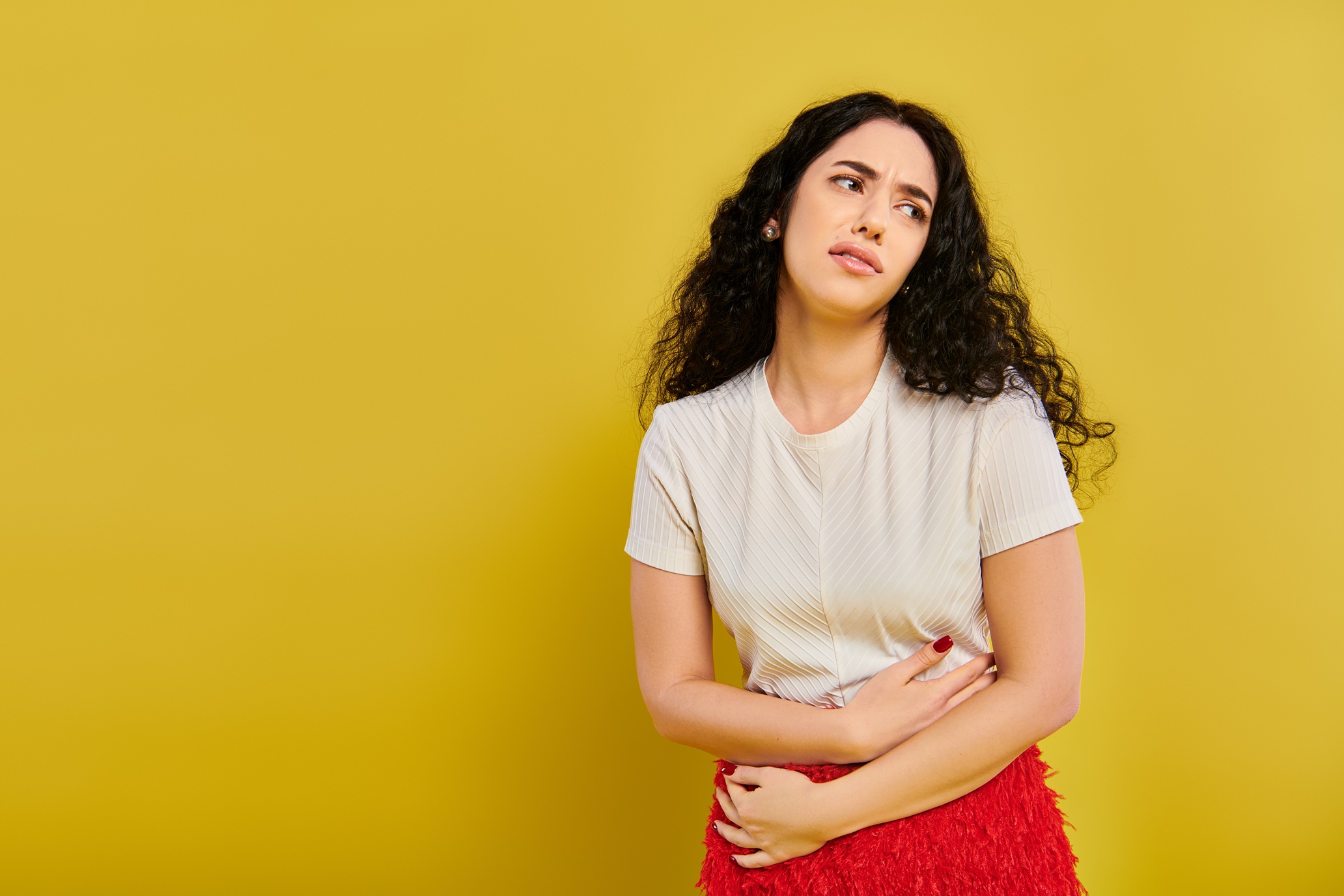 bored woman in white shirt and red skirt