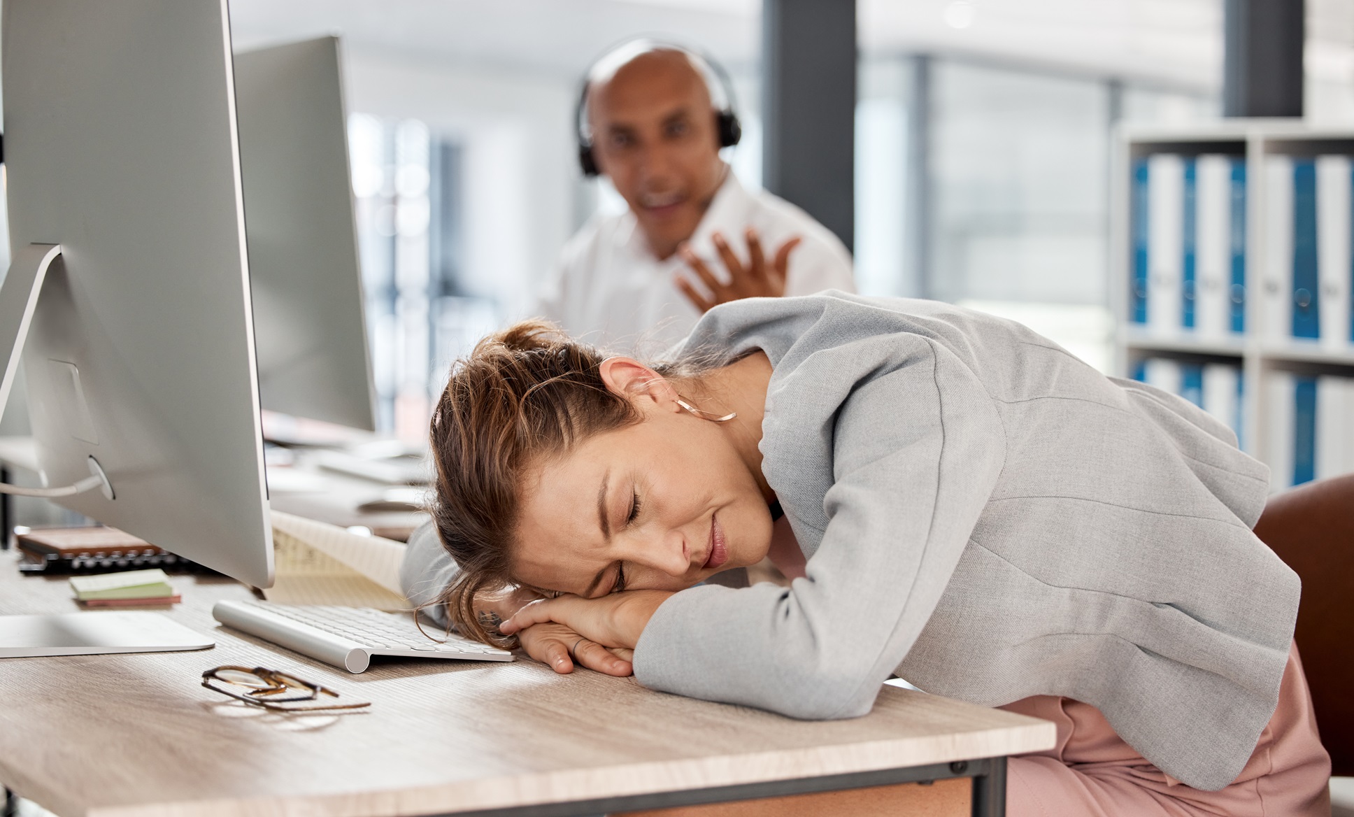tired burnout and sleeping call center worker