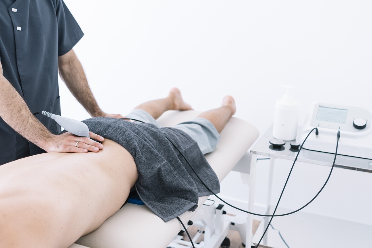 the physiotherapist treating a man using equipment 1