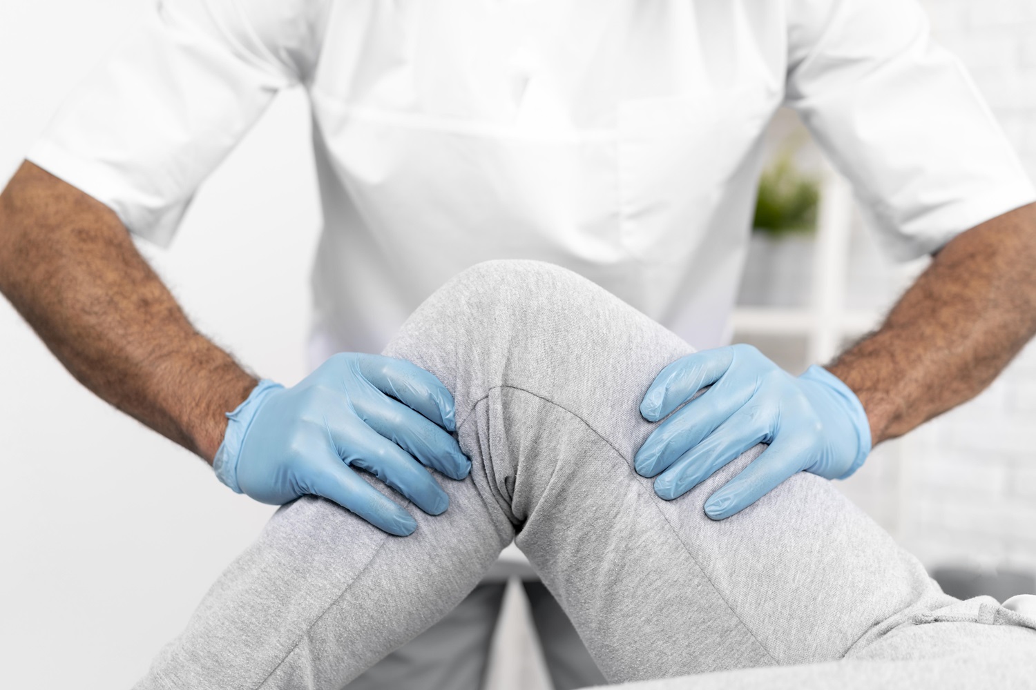physiotherapist checking woman s knee mobility