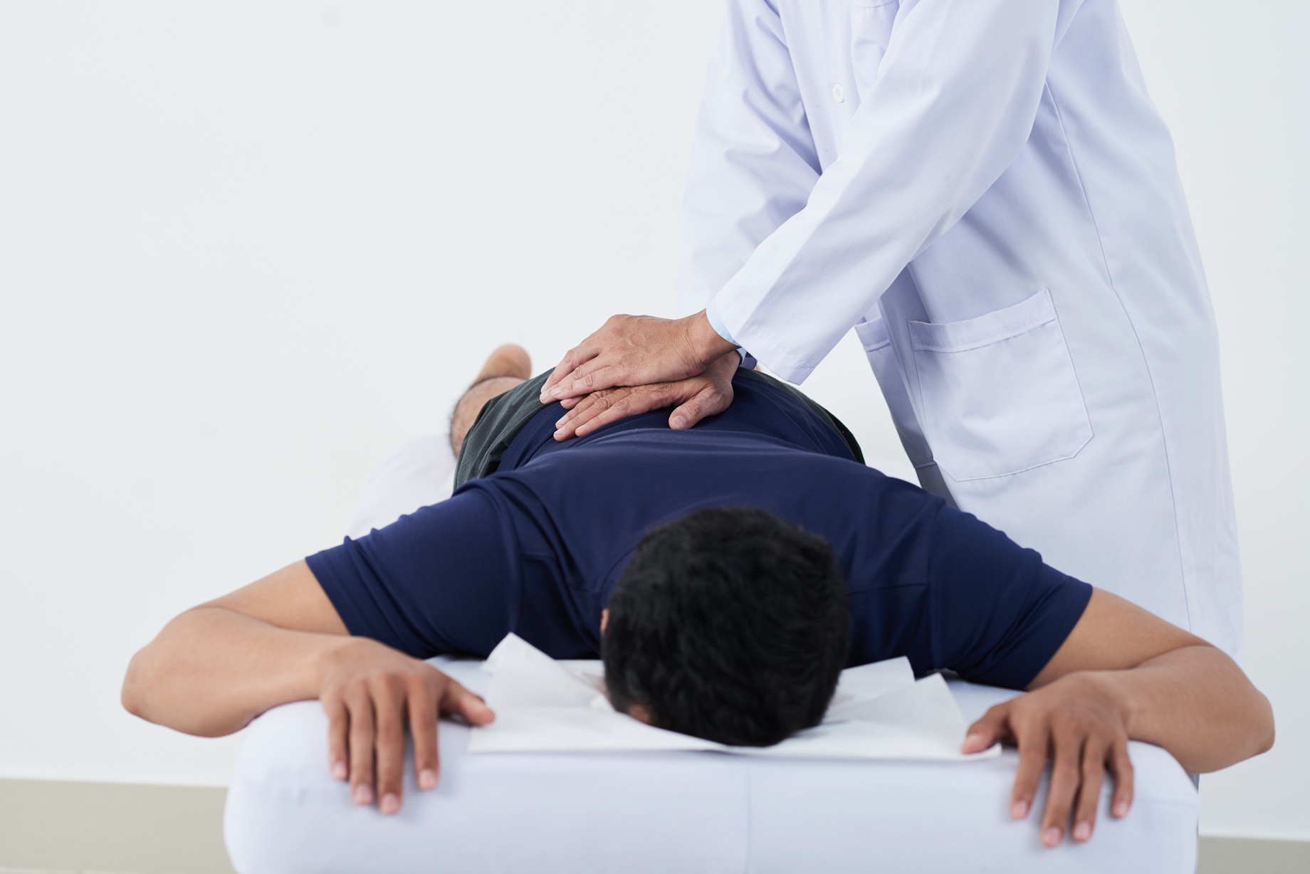 man receiving back massage from healthcare profess 2026