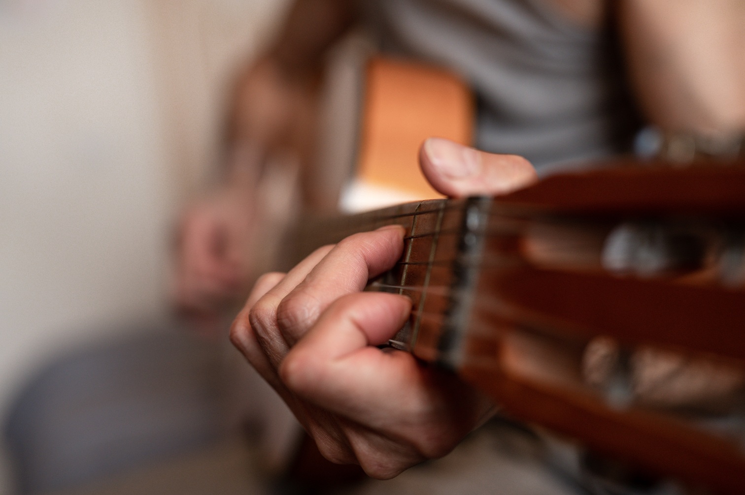 man playing acoustic guitar in close up view 2026