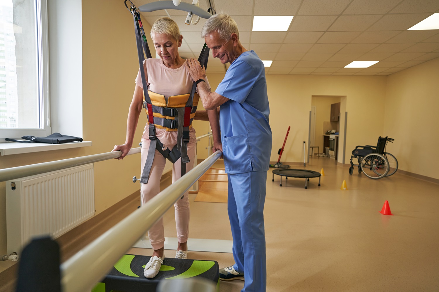 physical therapist helping stroke patient in rehab 