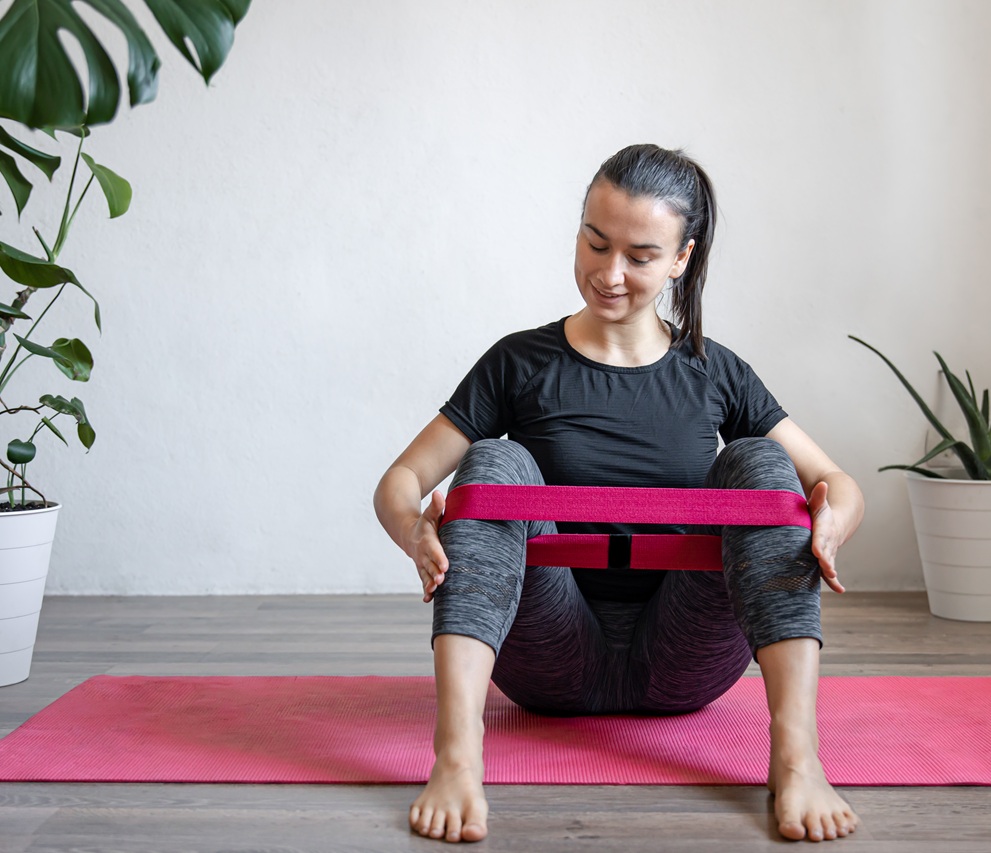 young woman doing exercises with a fitness elastic 2026