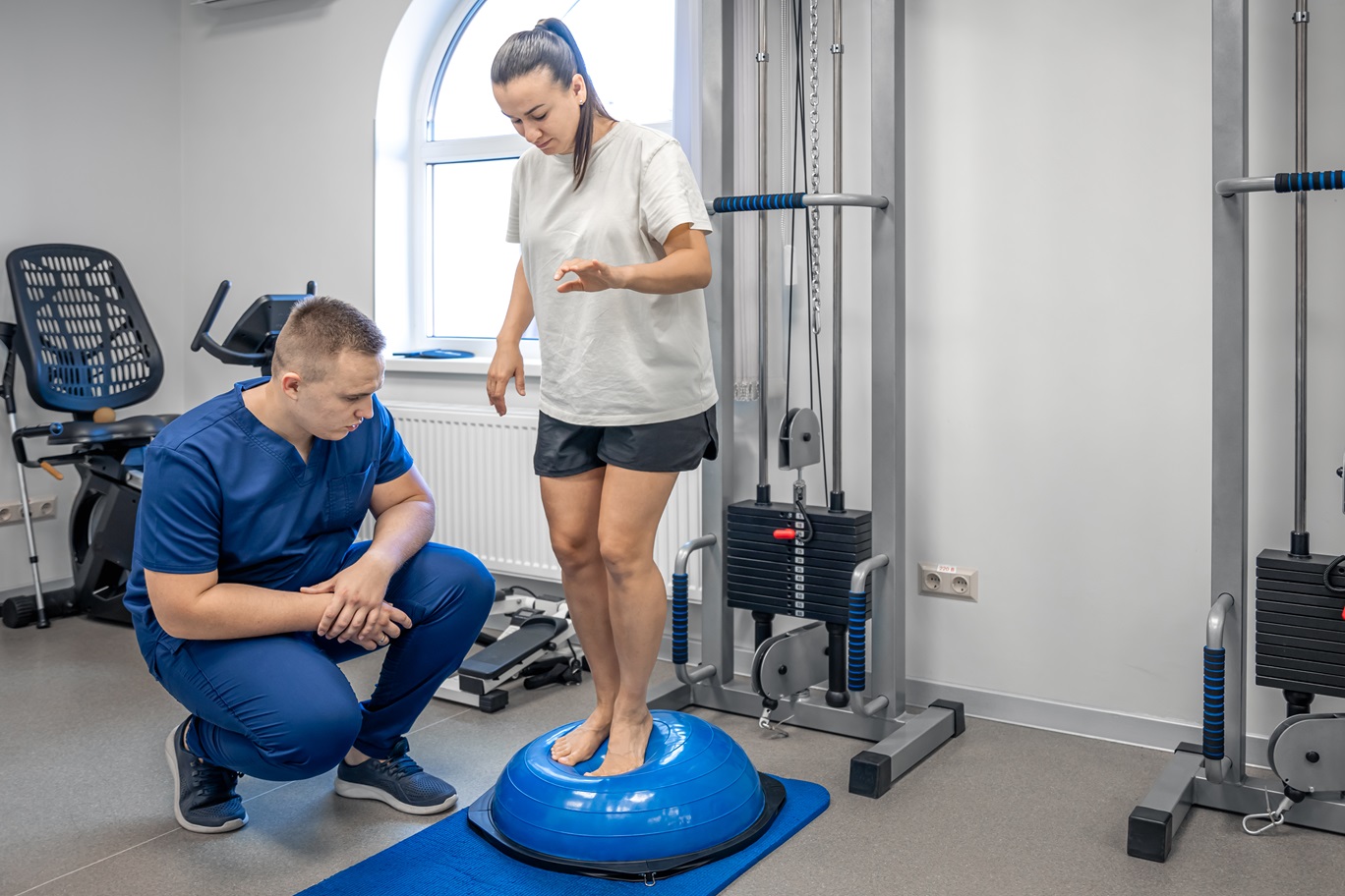 balance exercise with bosu ball woman and doctor