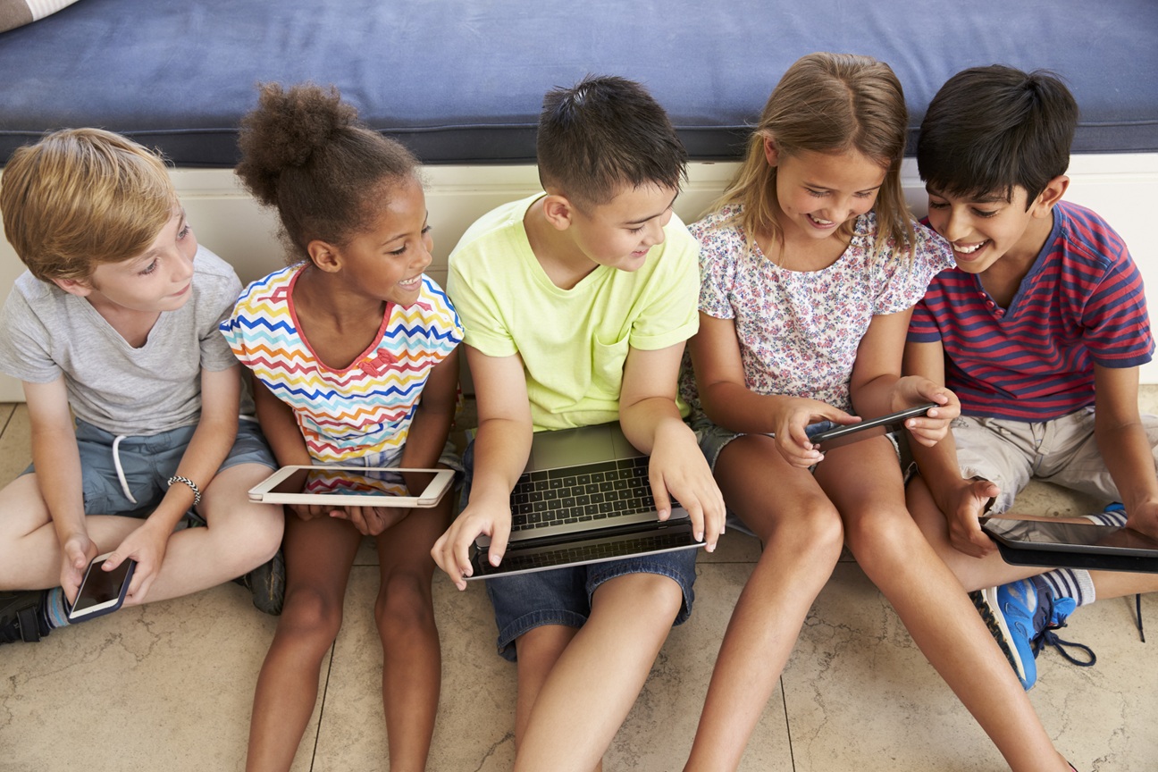 overhead shot of children sitting on floor using t 2026
