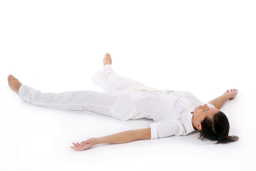woman relaxing in shavasana pose on white backgrou 2026
