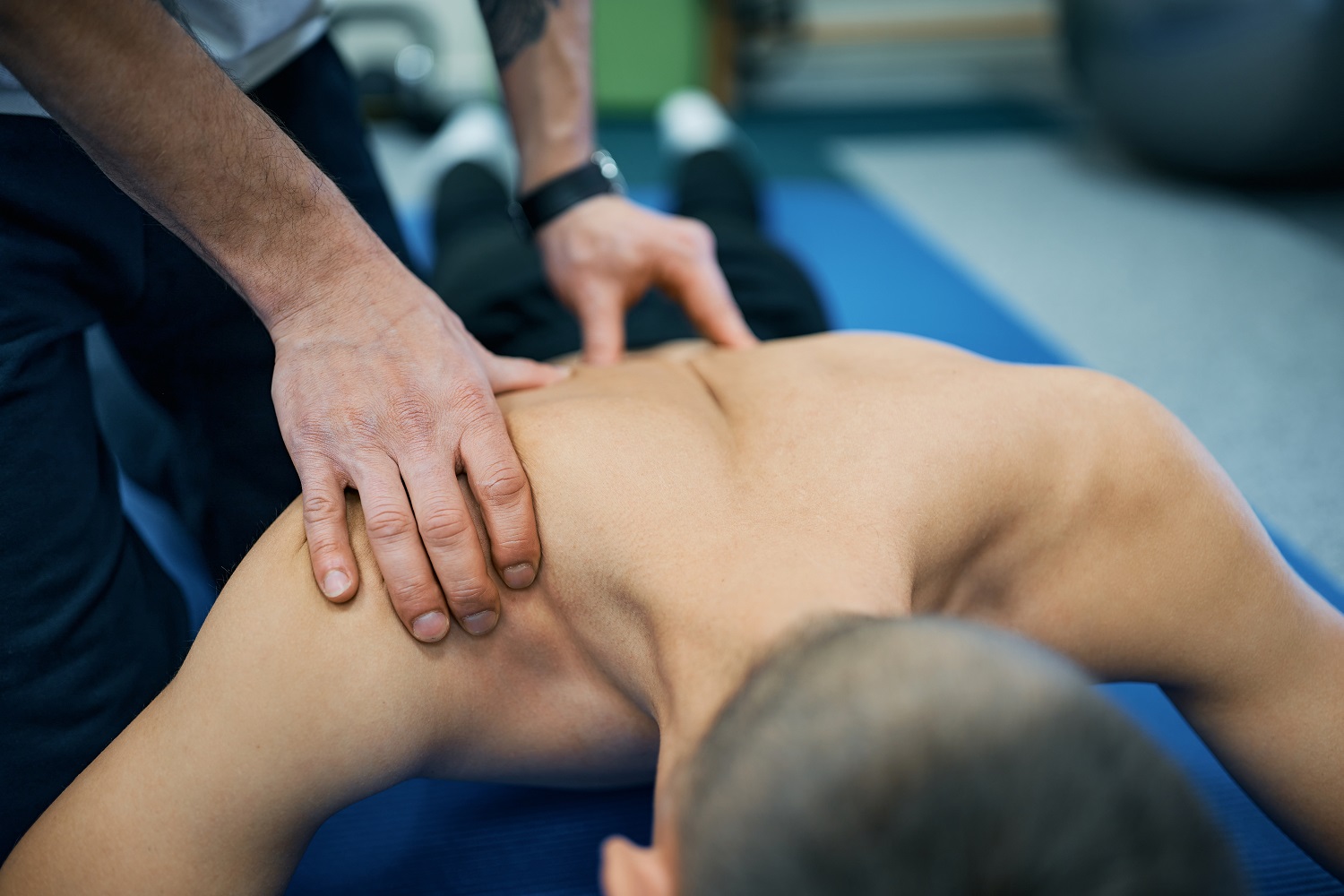 close up of physiotherapist massaging man