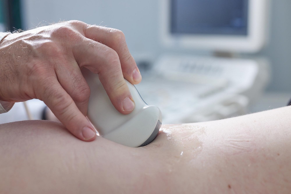 doctor examines with ultrasound