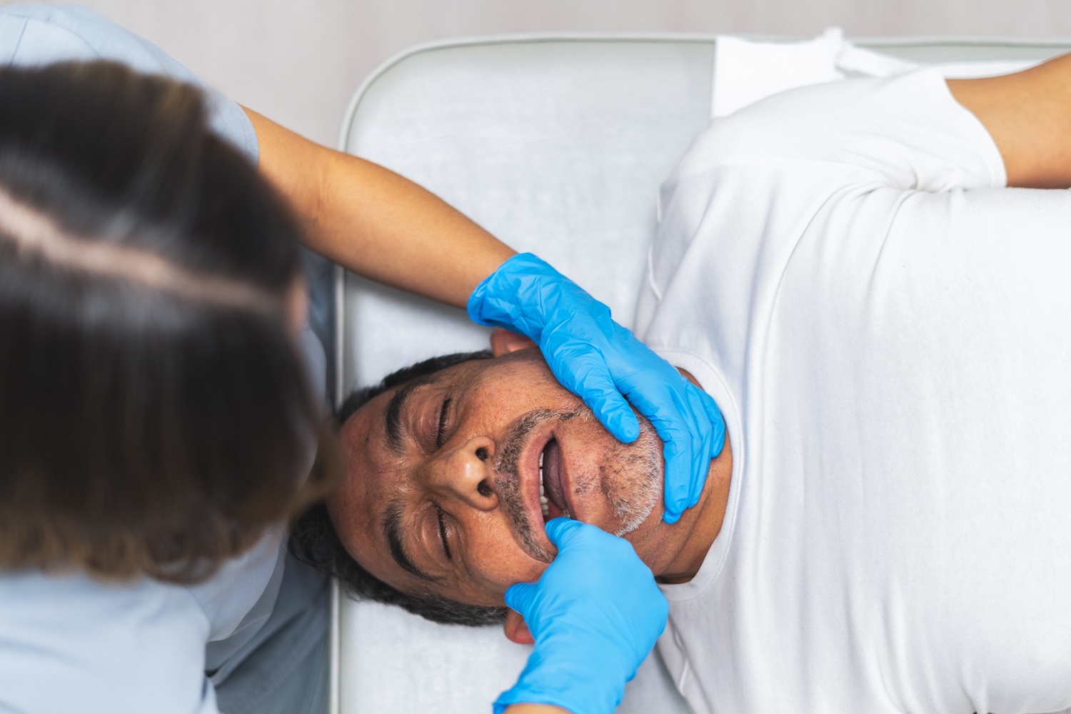 physiotherapist performing temporomandibular joint